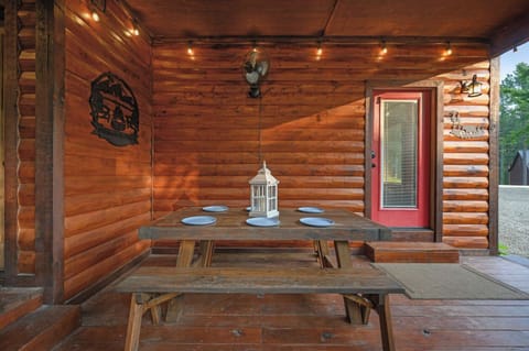 Gather around your rustic dining table under twinkling string lights, where warm wood surrounds you and every meal feels like a celebration.