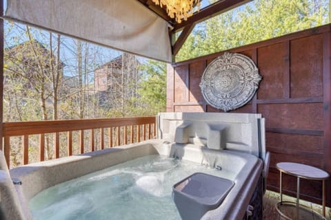 Soak in your bubbling hot tub while enjoying forest views from your covered deck retreat.