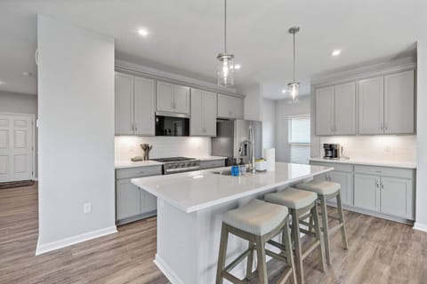 The chic, open kitchen offers ample space & all the comforts of home