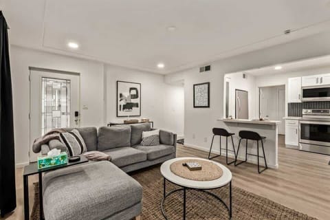 Cozy living space with Smart TV, decorative fireplace, and stylish décor, perfect for relaxing after a day in the city.
