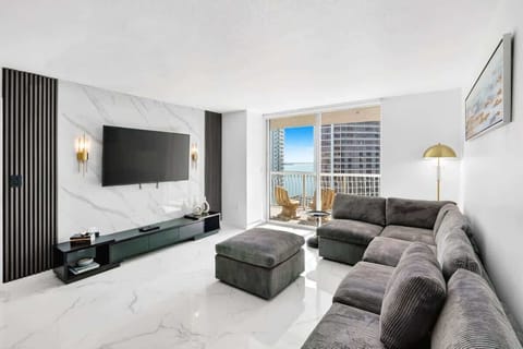 Bright and modern living room with comfortable seating and Smart TV.