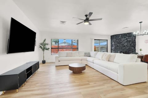 Relax in the spacious living room with a 75" Smart TV and cozy seating.