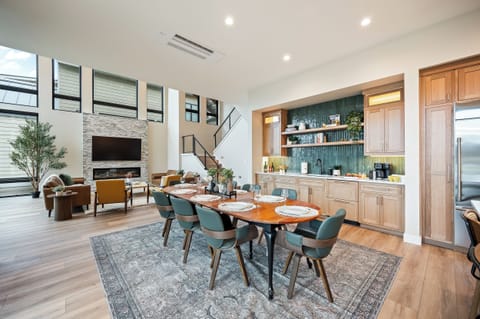 Main floor open concept living room, dining area, kitchen and wet bar. Enjoy lake view & glass wall sliding doors. Dining table has several extendable leaves and extra chairs to seat up to 12.