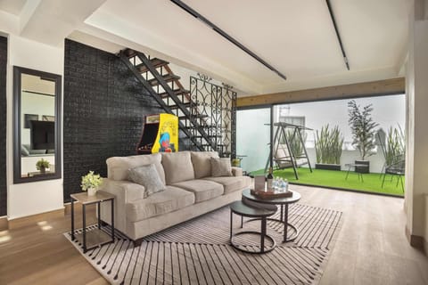 Relax in our inviting living room, featuring a stylish staircase and ample seating.