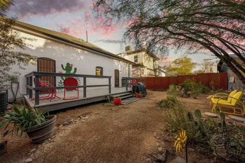 Spacious deck with outdoor seating and fenced backyard with grill and additional seating