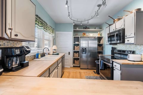 The open kitchen offers ample space & all the comforts of home