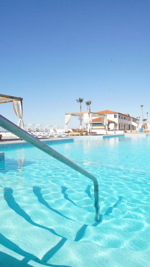 Outdoor pool, open 10:00 AM to 8:00 PM, free cabanas, pool umbrellas