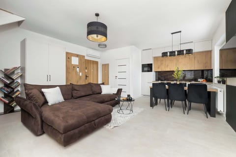 Relax in the stylish living room with a comfortable sofa and modern decor.