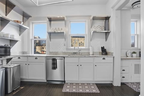Your fully equipped kitchen features granite countertops, stainless steel appliances, and charming city views—perfect for creating memorable meals during your stay.