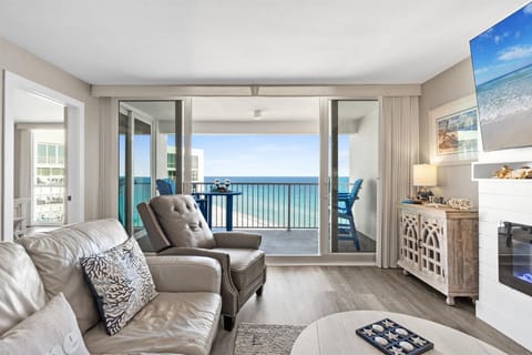 Relax in your oceanfront living room where stunning sea views frame your perfect beach getaway through expansive glass doors.