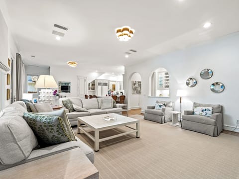 Sink into plush seating in this elegant living room where soft textures and warm lighting create your perfect retreat.