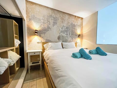 Beautifully furnished, the space features contemporary décor, a comfortable king-sized bed with quality linens, and stylish touches including an artistic globe wall print and ample built-in storage.