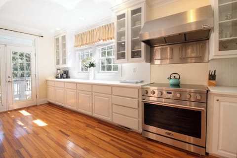 Cook your favorite meals in this bright, well-equipped kitchen with stainless steel appliances, ample counter space, and warm hardwood floors.