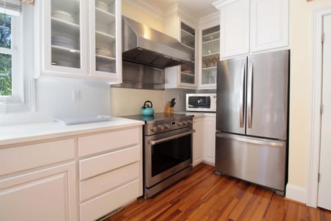Your fully equipped gourmet kitchen features stainless steel appliances and elegant white cabinetry, perfect for preparing memorable meals during your stay.