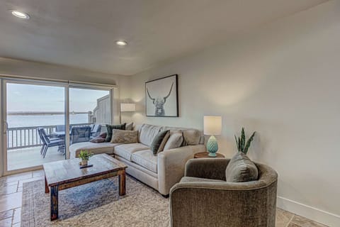 Open living area with lake views, dining space, and direct access to the waterfront deck.
