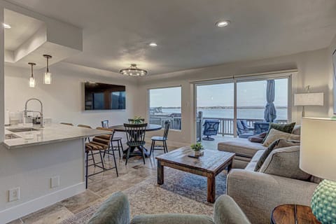 Open living area with lake views, dining space, and direct access to the waterfront deck.
