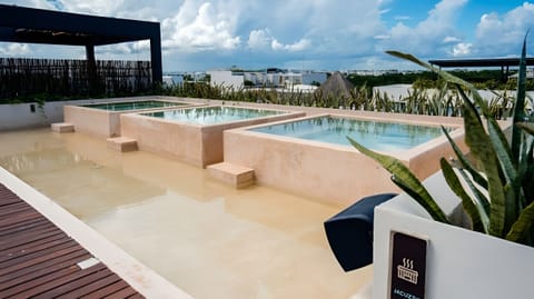 Soak in private jacuzzis with breezy rooftop views.