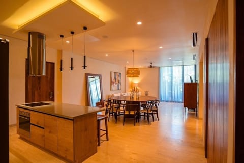 Unwind in the spacious open-plan lounge with soft, golden light.