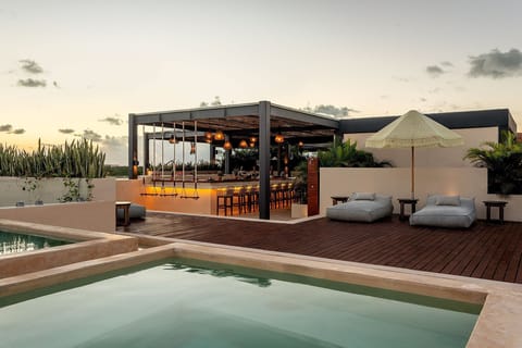 Unwind at sunset with infinity water, loungers, and glow.