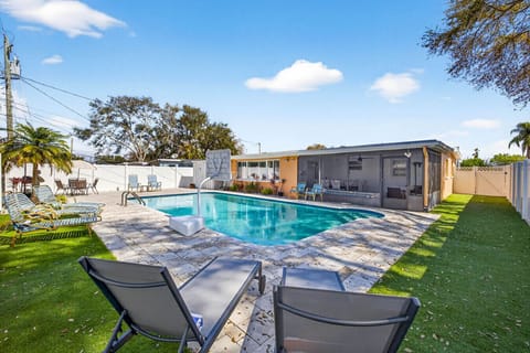 Resort-style pool with turf & loungers