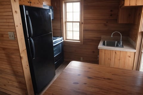 Warm and inviting kitchen with natural wood finishes modern stove and bright window lighting