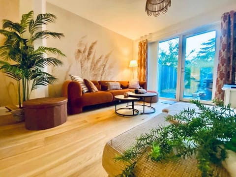 Stunning open plan living room, large oak flooring, velvet couch and many soft features including warm curtains and HUGE TV makes this such a cosy space. 