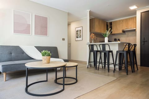 Cozy and modern living area with stylish decor and a convenient breakfast bar, perfect for relaxing or entertaining.
