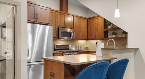 Sleek stainless appliances paired with comfortable bar seating