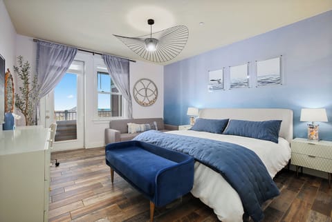 Master bedroom on the beach side with a king-size bed and a futon that can be us