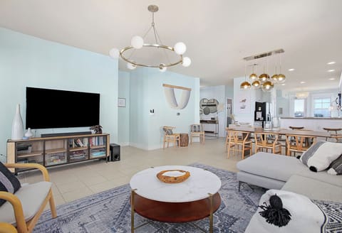 Enjoy the 77-inch smart TV in the living room with views facing the beach.