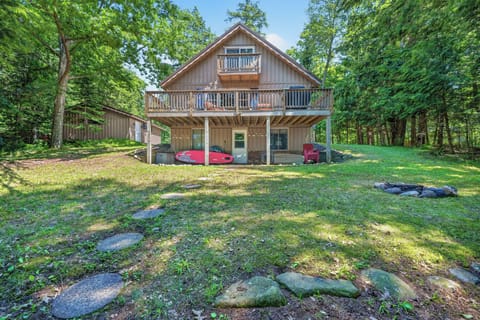 A cute little brown cabin with a walkout- patio and a upper level deck.