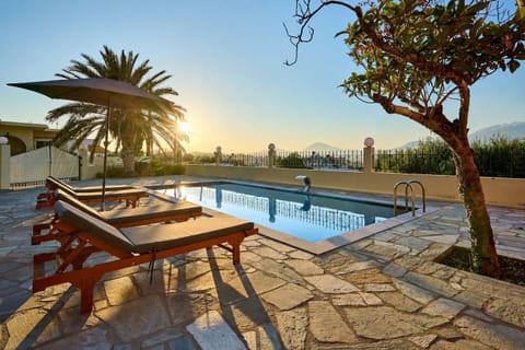 Stunning villa exterior at night with a glowing pool, perfect for evening relaxation