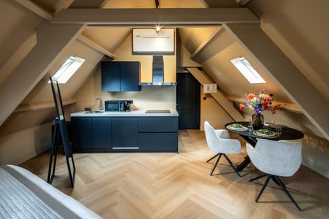 Fully equipped private kitchen with induction stove and cozy dining area. Stay close to everything while enjoying privacy and comfort.