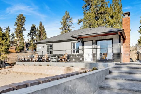Welcoming cabin entry surrounded by towering pine trees, offering fresh mountain air and a peaceful forest setting—the perfect first impression for your Big Bear Lake getaway.
