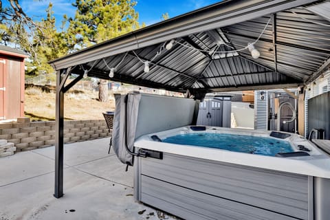 Private outdoor hot tub, surrounded by tall pines, perfect for relaxing under the trees after a day of adventure—enjoy peaceful forest views, fresh air, and a truly rejuvenating stay.