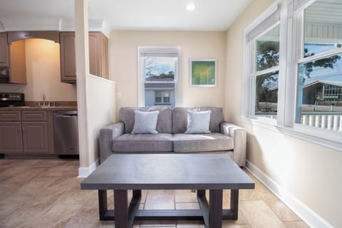 Sink into the plush sofa with morning coffee as natural light streams through large windows, creating your perfect retreat.