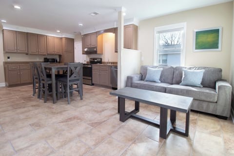 Your open-concept living space seamlessly blends comfort and functionality, featuring a fully equipped kitchen and cozy seating area perfect for relaxing after exploring.