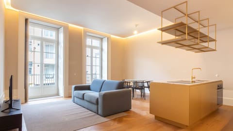 A bright open-plan space where modern comfort meets bold design, centered around a striking golden kitchen island.

#ModernLiving #CityStay #DesignApartment #PortugalHomes