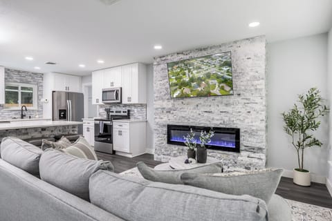 Sink into plush seating while your fireplace creates a cozy ambiance and the fully equipped kitchen awaits your culinary adventures.