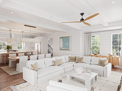 Sink into this expansive sectional sofa where you'll unwind under soaring ceilings with exposed beams and modern ceiling fans.