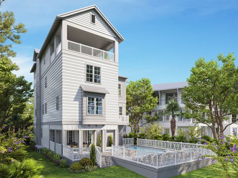 Multi-story coastal home featuring white siding, wraparound porches, and an elevated pool deck surrounded by lush tropical landscaping.