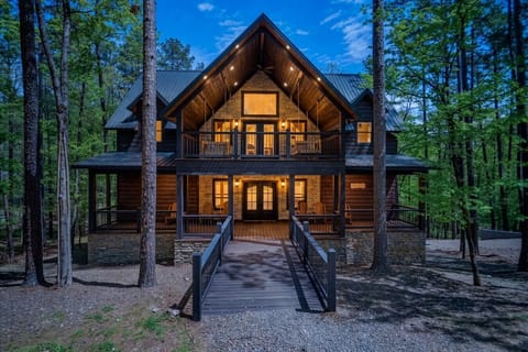 Exterior | Dusk View | Illuminated Luxury Cabin with Bridge Entrance