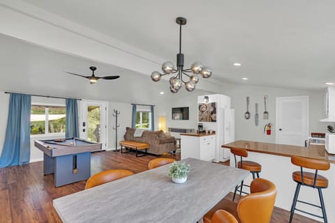 Your open-concept retreat features a stylish pool table, cozy seating, and a fully equipped kitchen—perfect for entertaining friends and family.