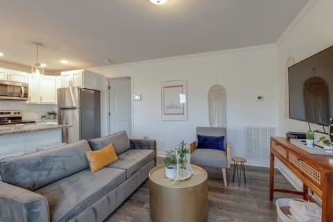 Open living area with a comfortable sofa and kitchen visible in the background