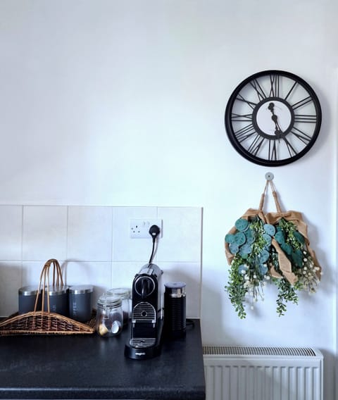 Stylish kitchen with Nespresso coffee station and wall decor
