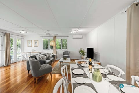 Large open plan living dining area with wooden floors throughout.