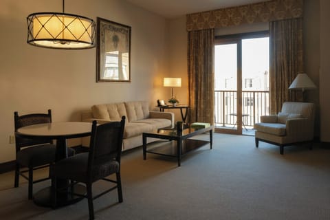 Stretch out in the spacious living room beside balcony light.