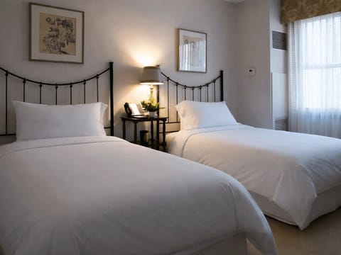 Settle in with roomy twin beds and bedside glow.