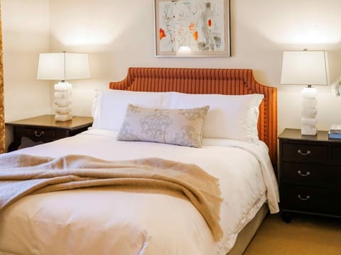 Sink into crisp linens beneath warm, boutique-style lighting.