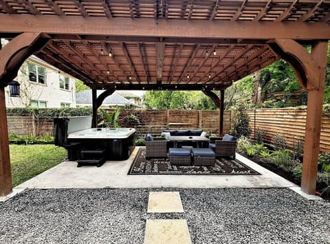 The shared outdoor space: hot tub, covered pergola, outdoor dining, and a lawn for the kids — shared with only one neighboring unit.
